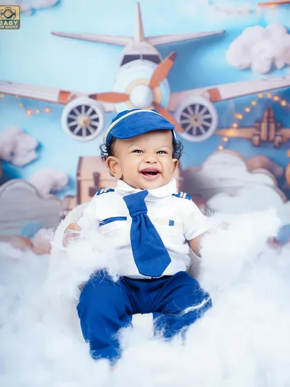 A close-up of our adorable co-pilot, surrounded by fluffy clouds. The pilot costume is one of many creative outfits I provide.