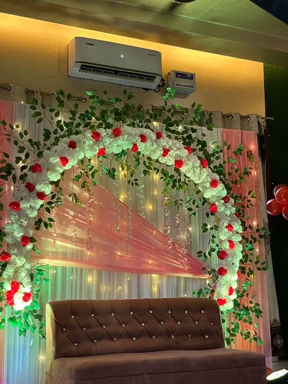 The lighting on this engagement backdrop adds a warm and celebratory glow.