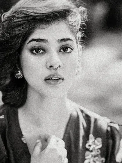 A grainy, black and white version of Ditipriya Roy's portrait. This artistic choice gives the image a timeless, film-like quality and emphasizes her expressive features.