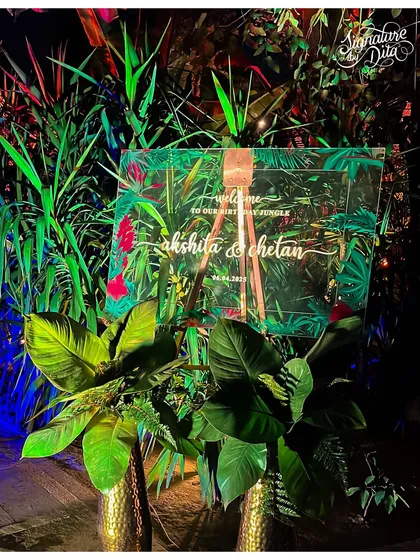 A personalized welcome sign is the first touchpoint for guests. For this jungle party, I designed a custom acrylic sign with a lush tropical print, setting the tone for the event from the moment of arrival.