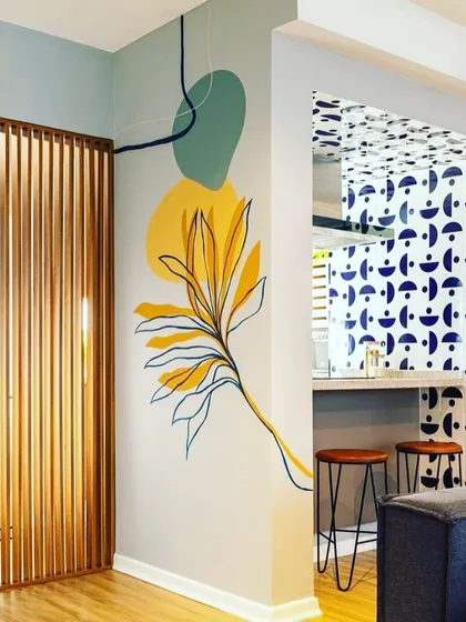 Our consultations often involve integrating colour with other design elements. This abstract wall art uses a curated palette of yellow and green to connect with the room's decor and create a focal point.