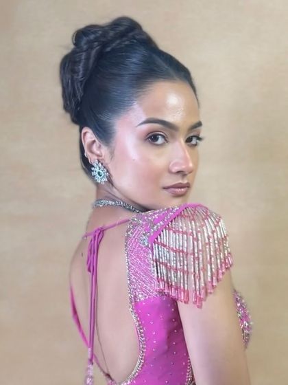 A side profile of the high braided bun, showing its height and intricate texture.