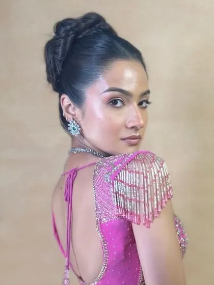 A side view of the high bun, showing its height and intricate braiding.