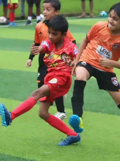 A tackle comes in as our U9 player tries to get a shot away.