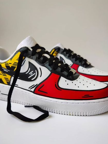 A full view of the Arsenal custom sneakers. The black laces and cartoon outlines tie the whole design together, creating a unique piece of fan memorabilia.
