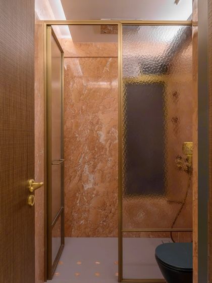 In this 2400 sq. ft. space, I created a bathroom that celebrates earthy tones. The striking bright orange marble is balanced by custom CNC cut flooring, creating a space that feels both invigorating and soothing.