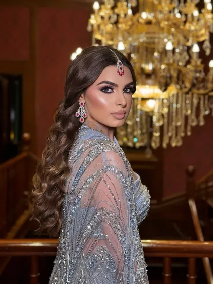 A dramatic shot showcasing the entire look. The chandelier in the background adds to the opulent and glamorous feel of her cocktail night.