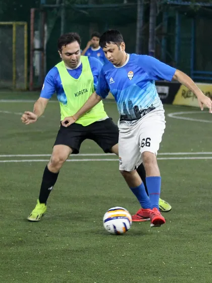 A player shields the ball from a defender during an intense moment in our Intra Cup. Our program is for working professionals who want to experience real, competitive football.