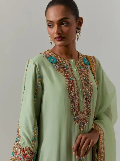 This pistachio green kurta features a stunning, multi-colored embroidered yoke. It's a beautiful example of how vibrant threadwork can transform a simple silhouette.