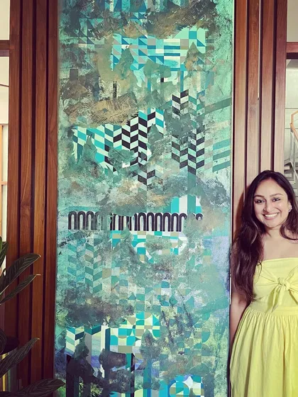 To give you a sense of scale, here I am standing next to an 8-foot tall custom art panel. I love working on large canvases like this because they allow me to create an immersive experience, blending soft, abstract backgrounds with sharp, geometric details that tell a personal story.