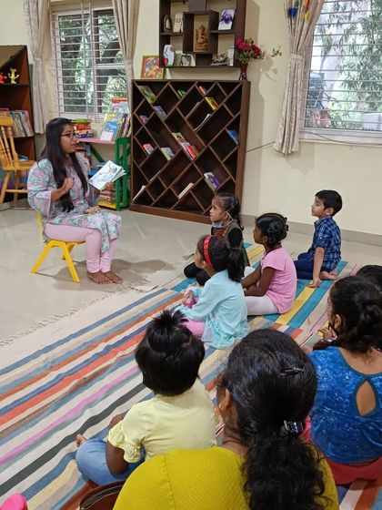 A wider view of the story session, showing the group's collective focus on the tale.