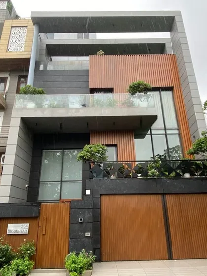 The finished building in Pitampura, a direct realization of the 3D design from image 21. The material application, window placements, and the unique curved element on the roof have all been constructed to match the original vision.