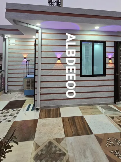 An exterior view of a rooftop porta cabin at dusk, with colorful wall lights creating a warm, inviting ambiance. The mixed-pattern tile flooring adds a unique, custom touch.