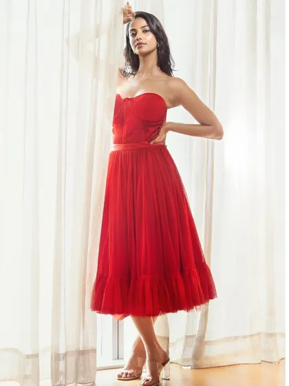 A duplicate of image 16, this image showcases a dramatic red gown styled for a high-fashion editorial, emphasizing silhouette and color.