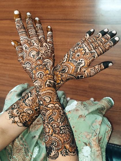 Another angle of the same dense bridal design, showing the detail and consistency of the patterns as they wrap around the arms.