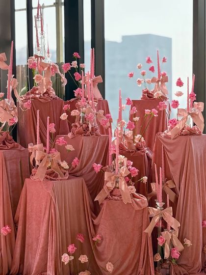 A slightly different angle of the pink velvet installation, showing how the light interacts with the fabric and the delicate details of the flowers and ribbons.