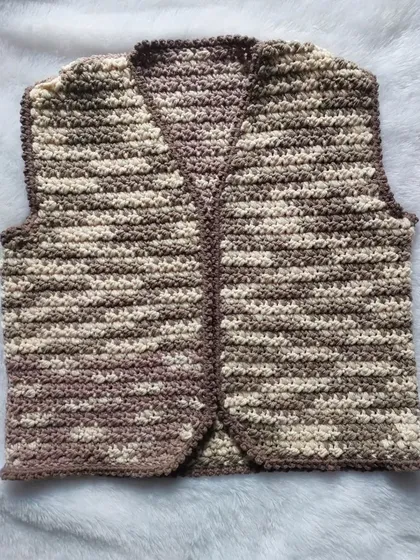 A flat-lay of the Lisa Vest, highlighting the textured stitch and clean V-neckline.