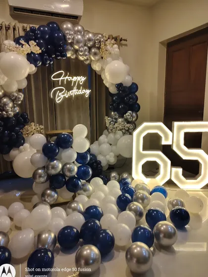 A full view of the 65th birthday decor, showing how it transforms a simple room into a stylish party space.