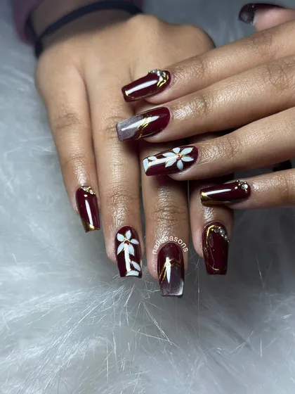 A bold and beautiful design with a deep burgundy base, hand-painted white flowers, and gold accents.