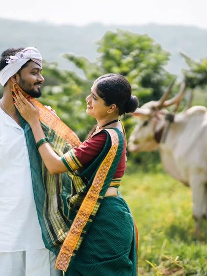 A tender moment during a village-themed pre-wedding shoot, capturing a gentle touch and a loving gaze.