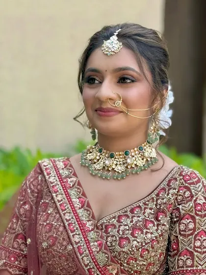 A close-up portrait focusing on the flawless base and defined eyes. The makeup is carefully layered to ensure it lasts all day while still looking natural.