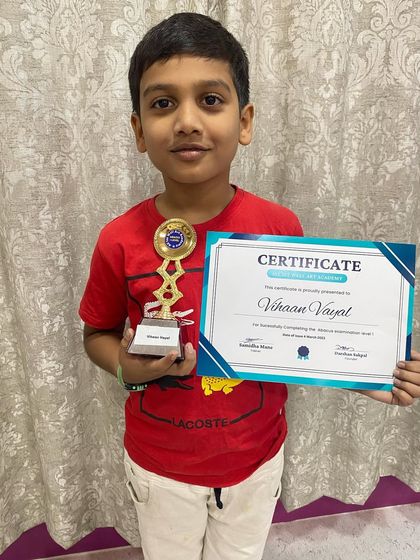 Vihaan Vayat proudly holds his certificate and trophy from our Abacus prize distribution event.