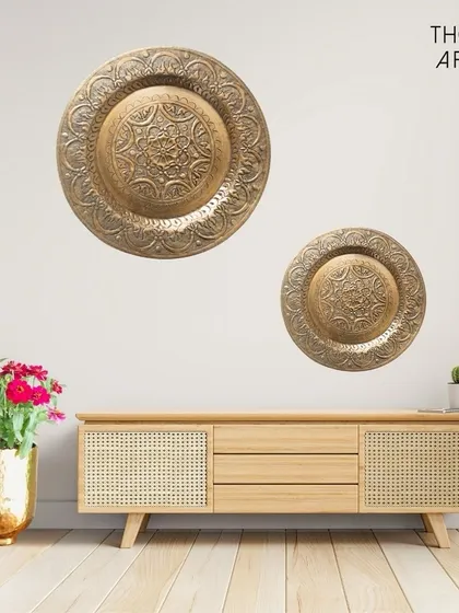 I love adding a touch of metallic warmth to a space. These embossed metal wall platters, shown here in an antique gold finish, are perfect for creating an accent wall. Their detailed patterns catch the light and add a layer of quiet luxury above a console or sideboard.