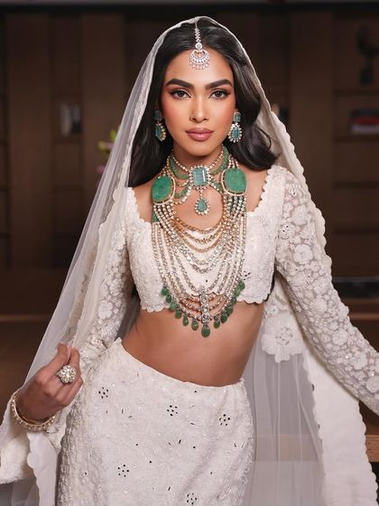 The full look. A modern bride in a stunning white lehenga, with makeup that is both elegant and timeless.