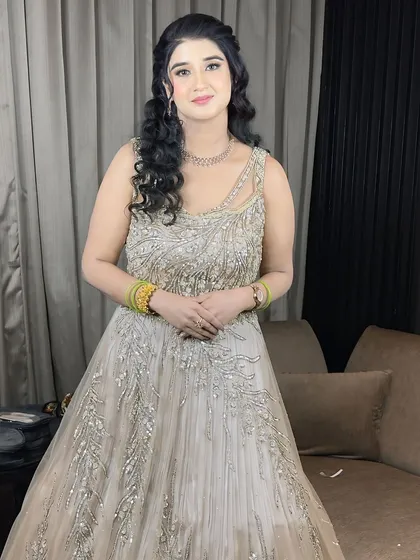 A full-length photo of the client, looking elegant and ready for her engagement party.