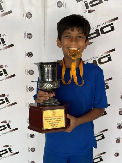 A champion in the making. One of our players proudly holding the trophy after a winning performance.
