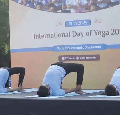 Demonstrating flexibility and strength with a synchronized bridge pose variation on stage.
