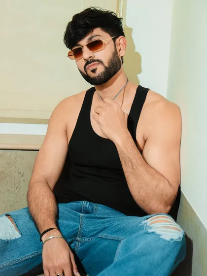 A casual and cool hotel shoot. This portrait in a tank top and ripped jeans has a relaxed, masculine vibe perfect for a lifestyle model's portfolio.