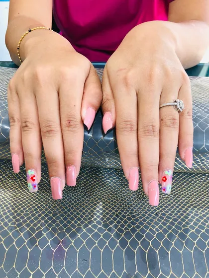 A full view of the hands with the pretty pink and floral design.
