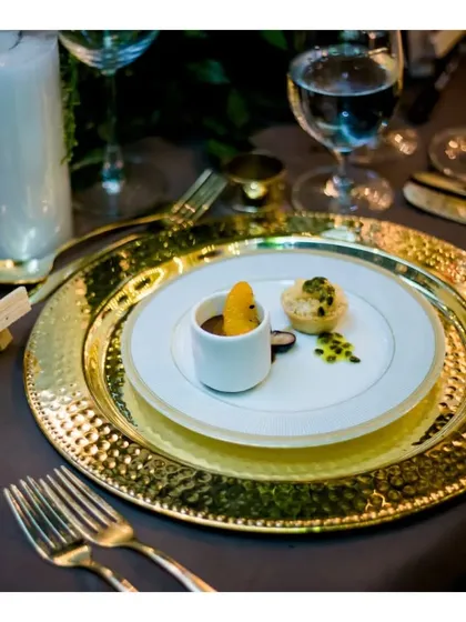 An elegantly plated dessert duo, featuring a warm apple crumble tart and burnt orange chocolate cremeux. This course is presented on stacked plates, showcasing our refined plating techniques for a memorable end to the meal.