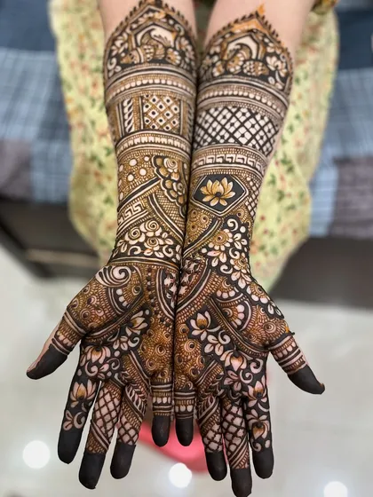A full bridal set for bride Ayesha, featuring lotus motifs, geometric bands, and full coverage on hands and feet.