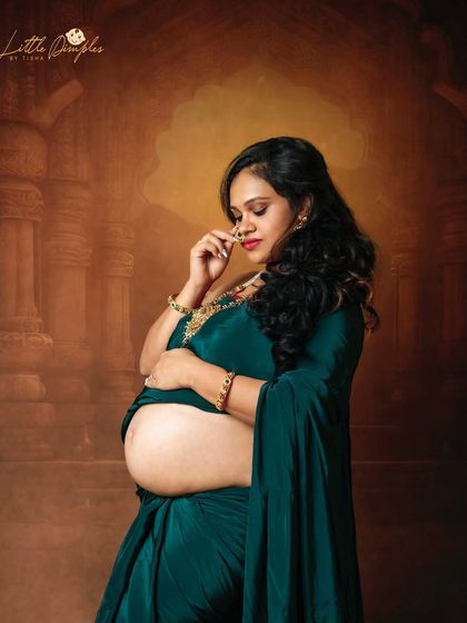 A close-up portrait showing the beautiful details of the jewelry and the gentle expression of this mom-to-be. The traditional nose ring adds a perfect touch.
