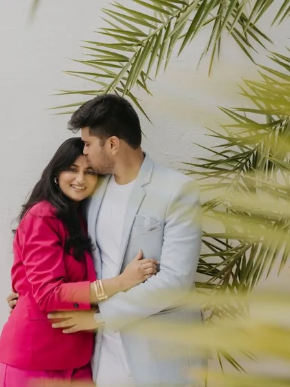 A simple, tender moment of comfort and affection. This candid portrait highlights the gentle connection between the couple, framed by soft natural light and lush greenery.