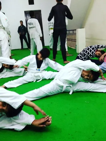 Flexibility is fundamental. Our students work on split stretches as part of their conditioning routine to improve their range of motion for high kicks and advanced techniques.