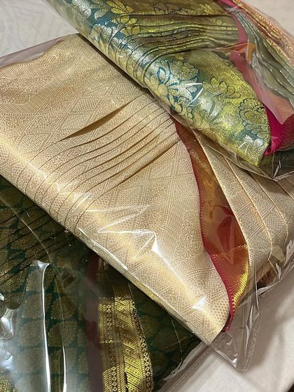 Three beautiful silk sarees, packed and ready. This service is ideal for protecting your investment in fine sarees.