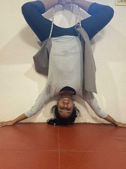 Using props like wall ropes is a key part of my teaching method for advanced poses. Here you can see my students in an inverted Baddha Konasana (Bound Angle Pose), using the ropes to decompress the spine and open the hips safely.