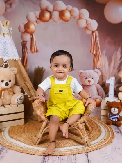 A similar boho theme with a different color palette. This little boy in his bright yellow overalls looks absolutely adorable among the teddy bears.