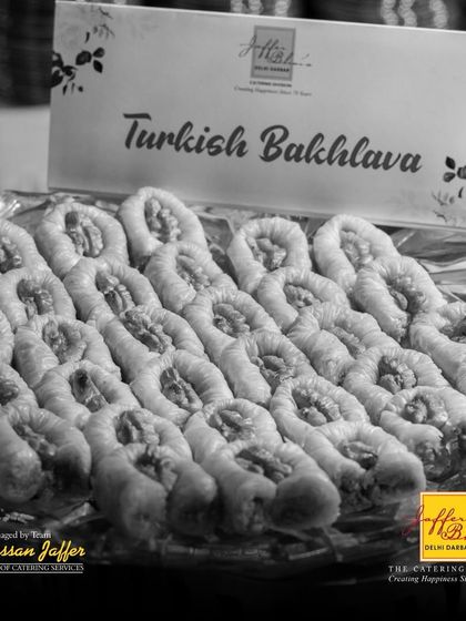 A black and white shot highlighting the intricate layers and nutty filling of our authentic Turkish Bakhlava, a testament to its rich texture and flavour.
