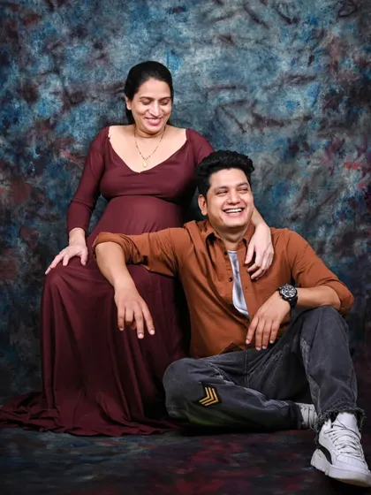 Capturing genuine laughter and joy is my goal. This candid moment from a couple's maternity shoot shows the excitement and happiness of their journey together.