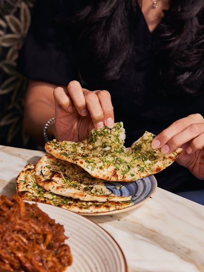 There's nothing like tearing into a hot, fresh piece of garlic naan. All our breads are made in-house, and they are an essential part of the Comorin dining experience.