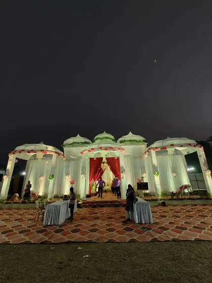 This night view shows how I use lighting to transform a space. The white dome-topped structures, inspired by traditional Indian architecture, are illuminated to create a magical and inviting atmosphere for an evening event.