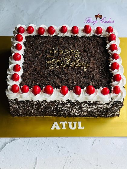 A classic, rich, and flavorful Black Forest sheet cake, generously topped with chocolate shavings and cherries.