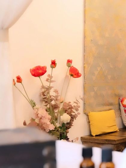 Immerse yourself in a realm of refined elegance. The thoughtful decor in my salon, like these flowers and cushions, is chosen to make your experience feel special and luxurious.