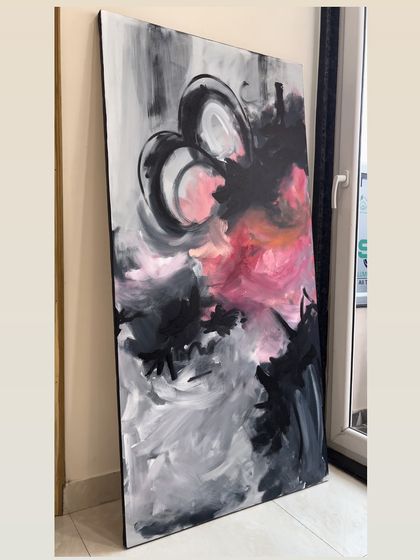 A large abstract canvas with expressive strokes of black, grey, and vibrant pink. This style is perfect for making a bold, modern statement in a living room or creative office space.