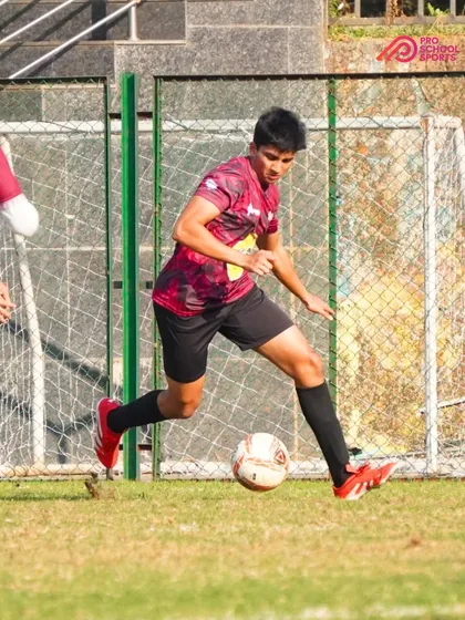 A player dribbles towards the opponent's goal, ready to create a scoring chance.