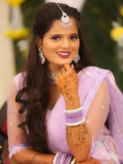 A soft and dreamy Sangeet look with a modern pastel lehenga. The makeup features a luminous base, sparkling diamond jewelry, and a bold lip, ensuring you are the star of the dance floor.